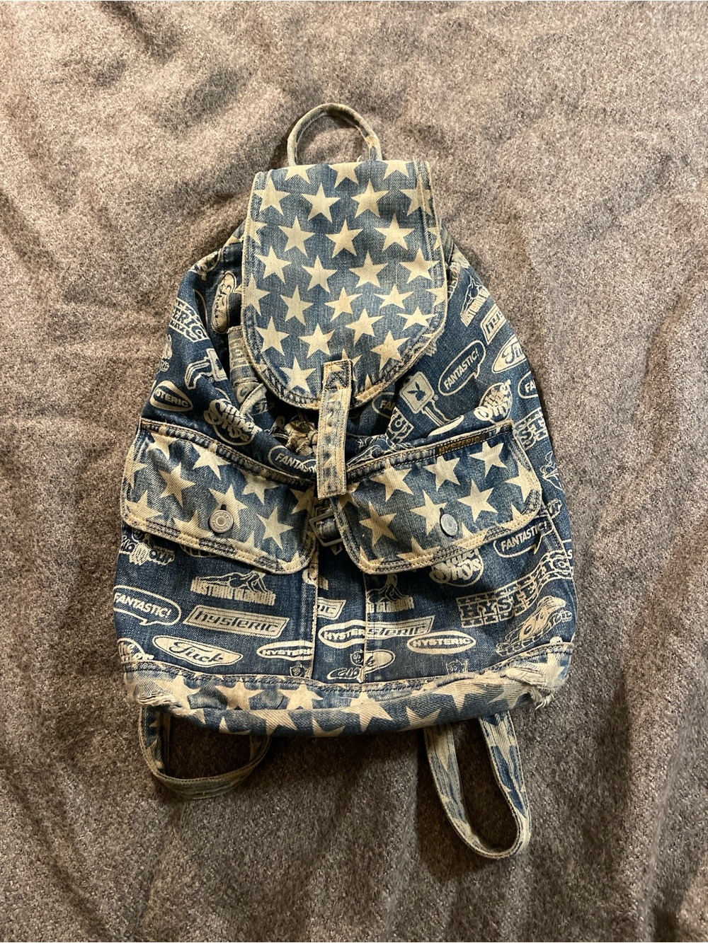 Hysteric Glamour denim backpack with white stars and repeating text graphics